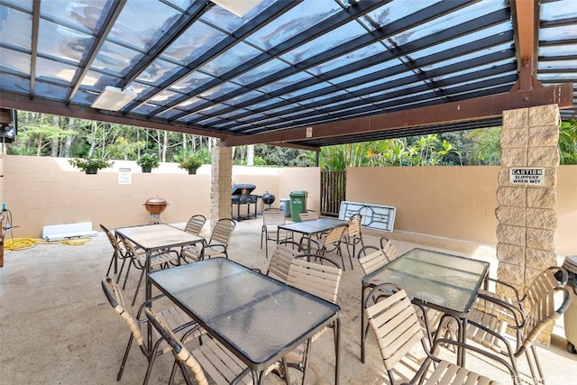 view of patio featuring fence and outdoor dining space