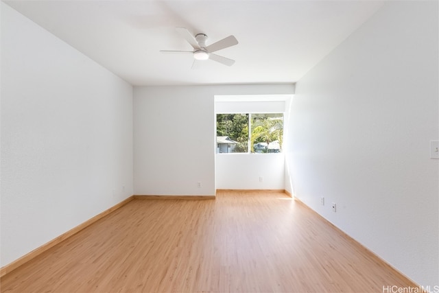 empty room with light wood-style flooring, baseboards, and a ceiling fan