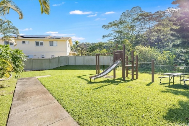 view of yard featuring fence and a playground