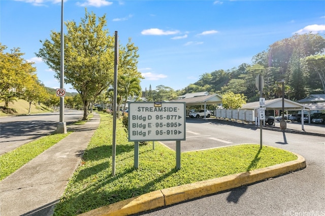 exterior space featuring sidewalks, traffic signs, and curbs