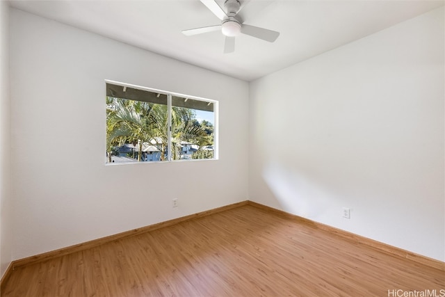 empty room with light wood-type flooring, ceiling fan, and baseboards