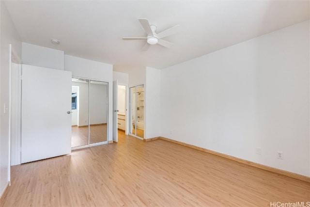 unfurnished bedroom with light wood-style flooring, baseboards, a ceiling fan, and ensuite bathroom