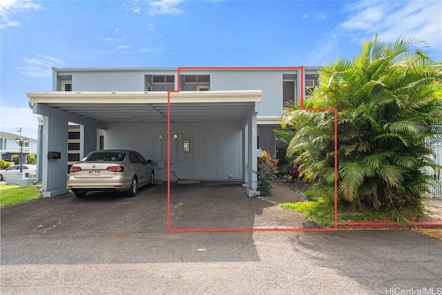 view of parking featuring a carport and driveway