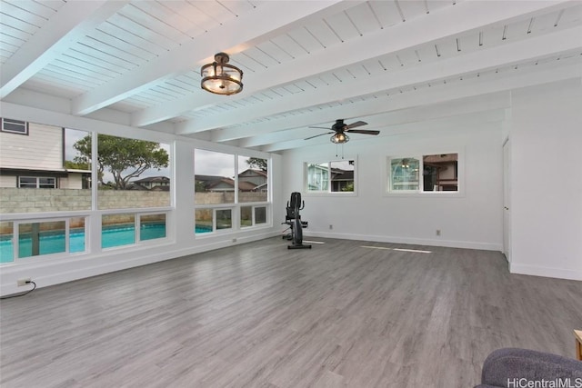 exercise room featuring plenty of natural light, baseboards, and wood finished floors