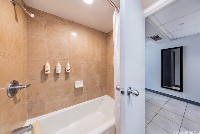 bathroom featuring tile patterned flooring, visible vents, and shower / bath combo