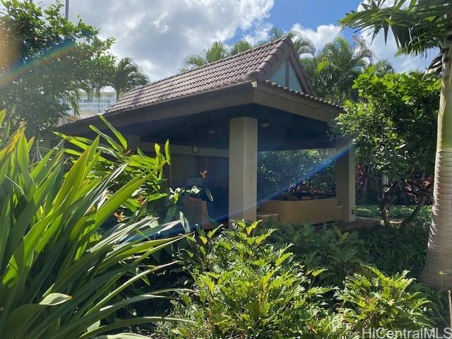 view of property exterior with a tile roof