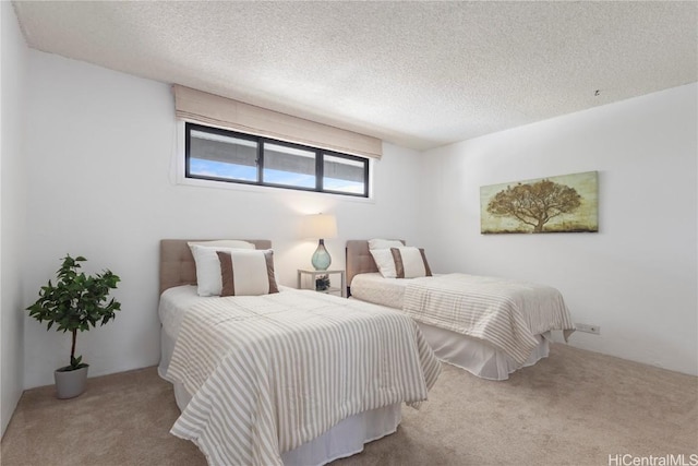 bedroom with a textured ceiling and carpet floors