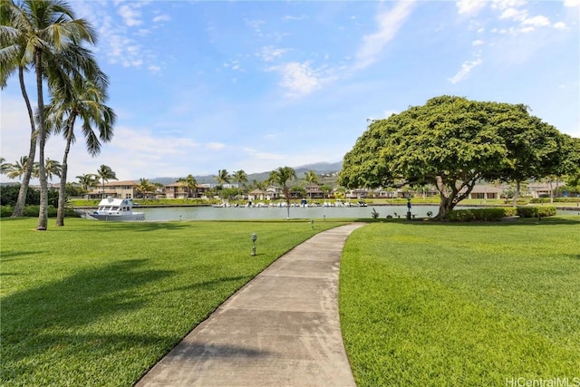 view of property's community with a yard and a water view