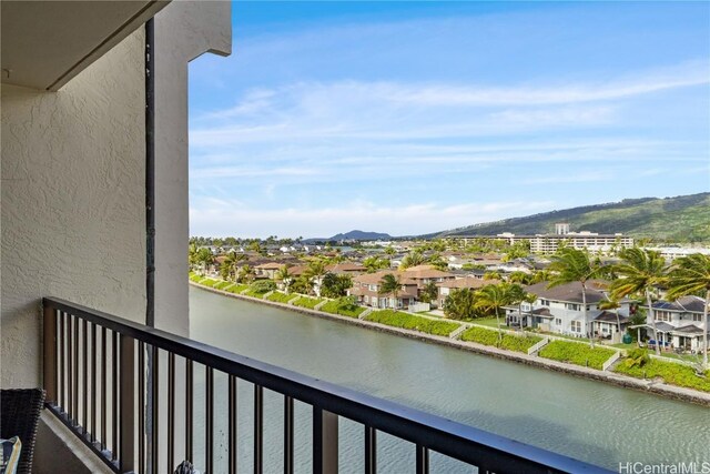 balcony with a residential view and a water and mountain view