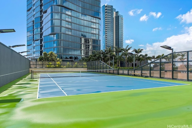 view of tennis court with fence