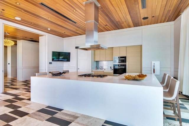 kitchen with wooden ceiling, island exhaust hood, stainless steel gas cooktop, and light floors