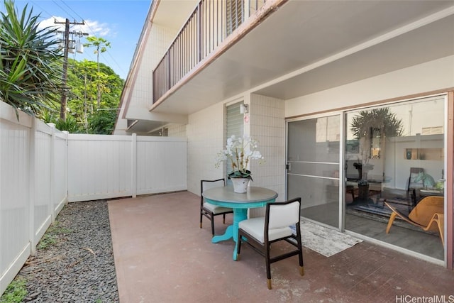 view of patio featuring a fenced backyard and a balcony