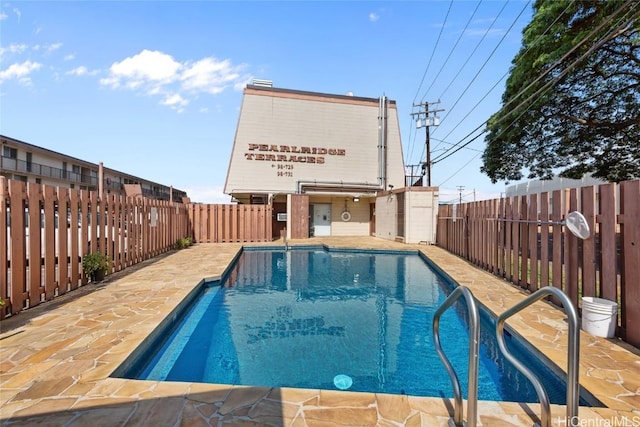 view of swimming pool with a patio area, a fenced backyard, and a fenced in pool