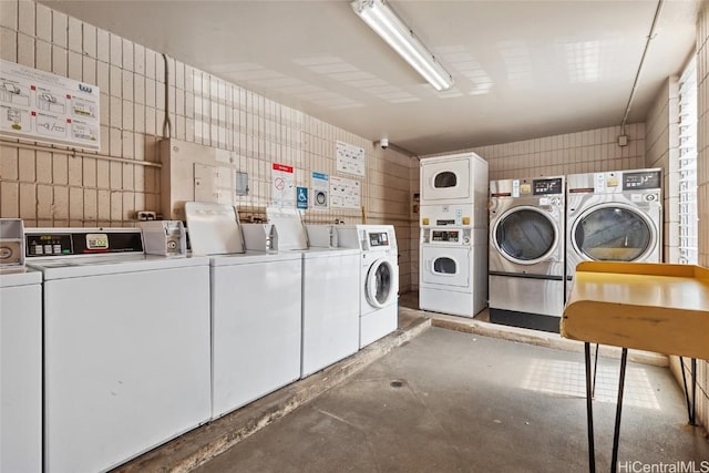 shared laundry area featuring independent washer and dryer and stacked washer / drying machine