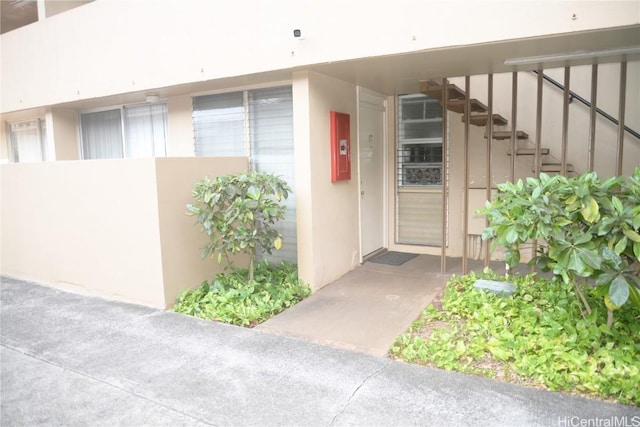 entrance to property with stucco siding