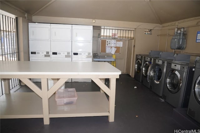 shared laundry area with stacked washer and dryer