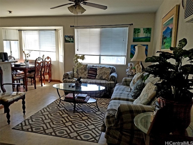 living area featuring ceiling fan and a wall mounted AC