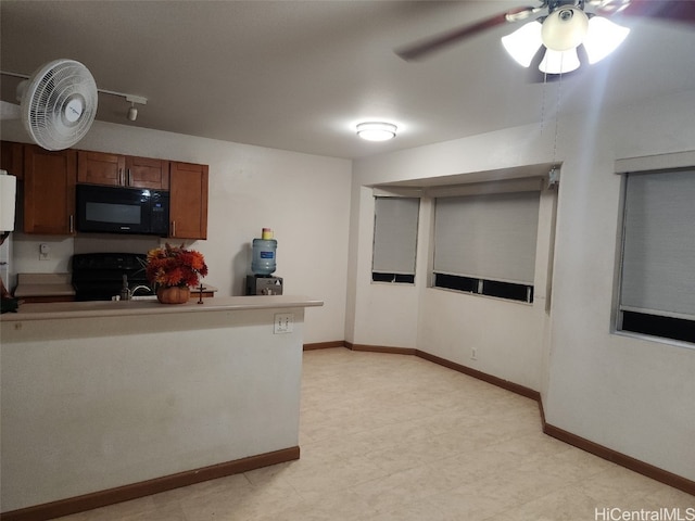 kitchen featuring range with electric cooktop, baseboards, a ceiling fan, brown cabinets, and black microwave