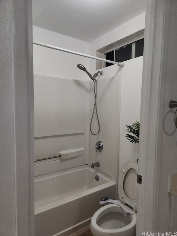 bathroom with toilet and washtub / shower combination