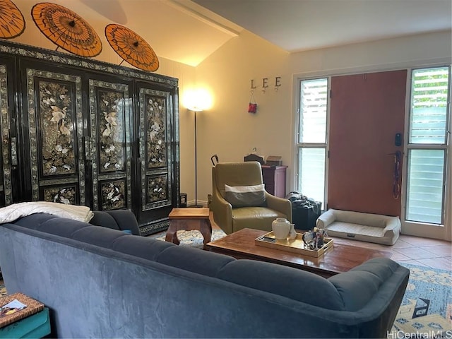 living area featuring vaulted ceiling and tile patterned flooring