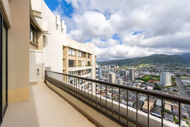 balcony with a mountain view and a city view