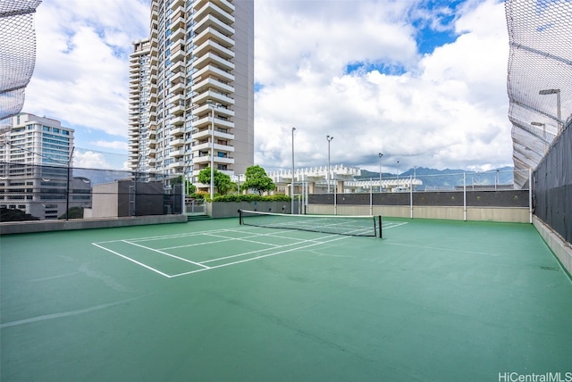 view of tennis court with fence