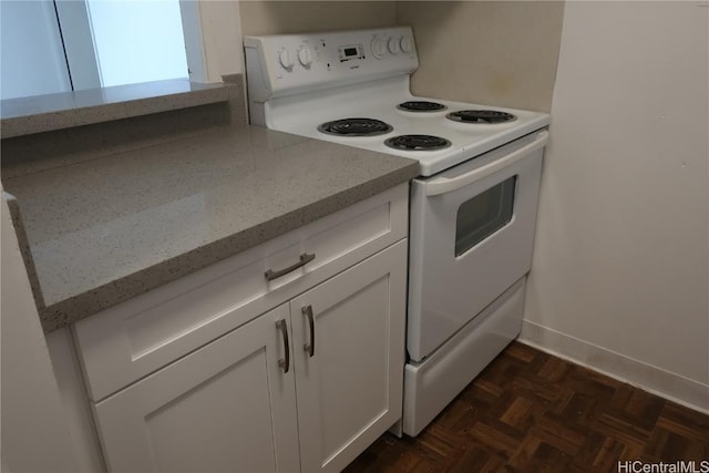 kitchen with baseboards, white electric stove, white cabinetry, and light stone counters