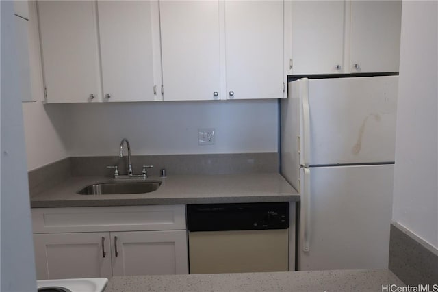 kitchen with light countertops, white appliances, white cabinets, and a sink