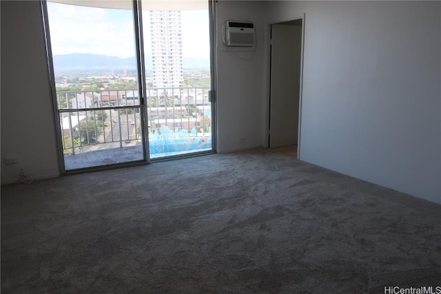 empty room with a city view, carpet flooring, and a wall mounted AC