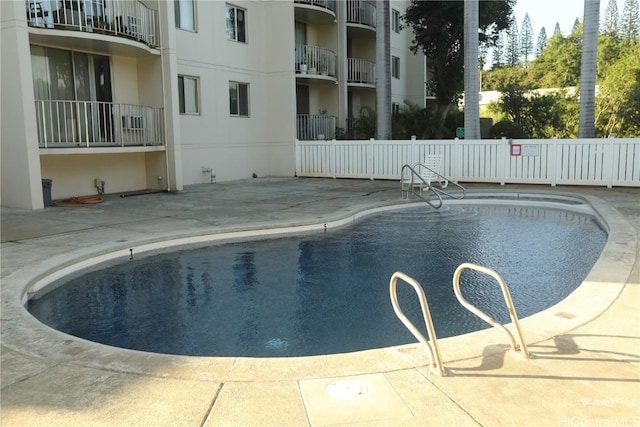 pool featuring a patio area and fence