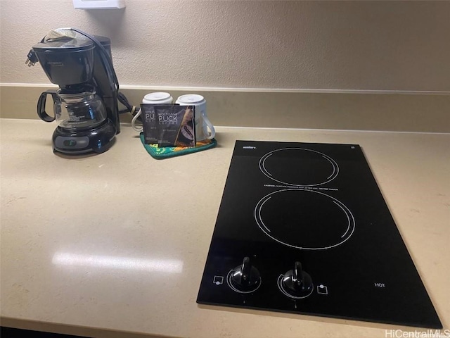 details with light countertops and black electric stovetop