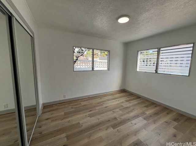 4509 Luaole St, Honolulu, HI 96818 - unfurnished bedroom featuring baseboards, a closet, and light wood-style floors