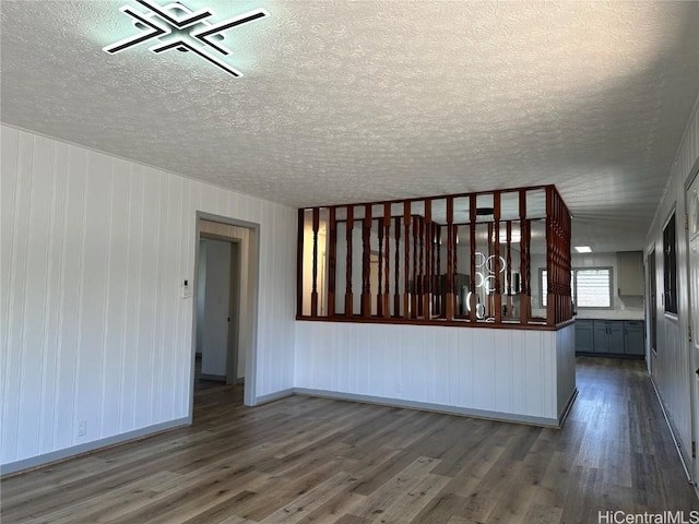 4509 Luaole St, Honolulu, HI 96818 - spare room featuring a textured ceiling, wood finished floors, and baseboards