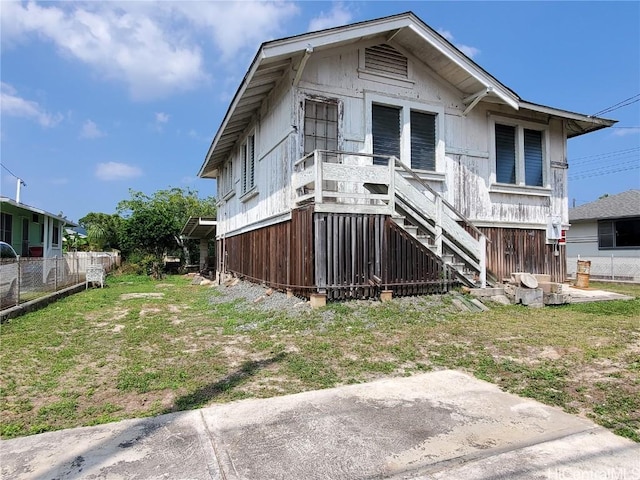 view of front of house with stairway and fence