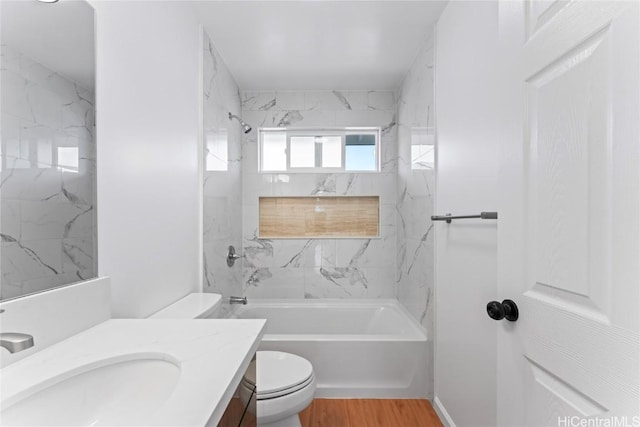 full bathroom with shower / tub combination, vanity, toilet, and wood finished floors