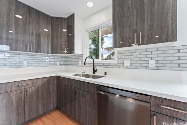 kitchen with a sink, modern cabinets, dark brown cabinets, and dishwasher