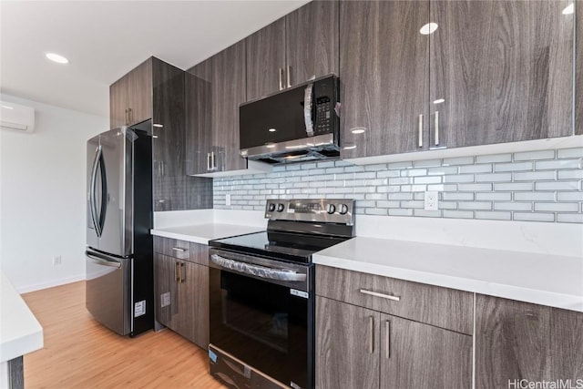 kitchen with stainless steel appliances, light wood finished floors, modern cabinets, and light countertops