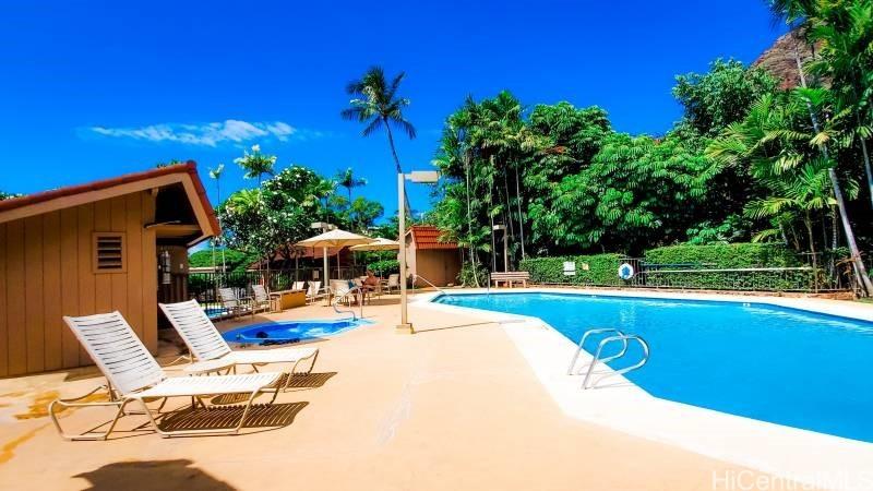 community pool featuring a patio area and fence