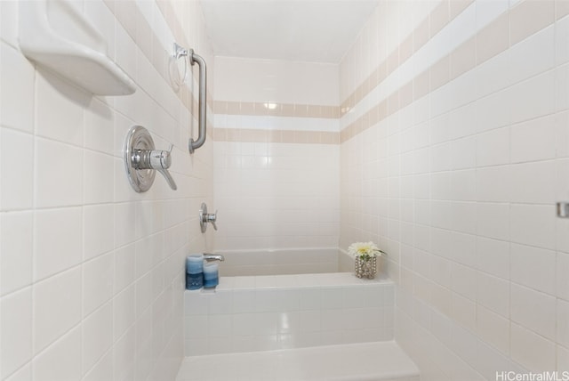 bathroom featuring a bathing tub and a tile shower