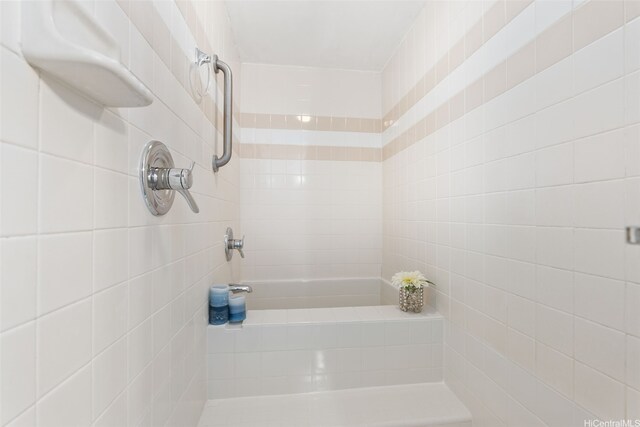 2440 Kuhio Ave Unit 1101, Honolulu, HI 96815 - bathroom featuring a tile shower and tile walls