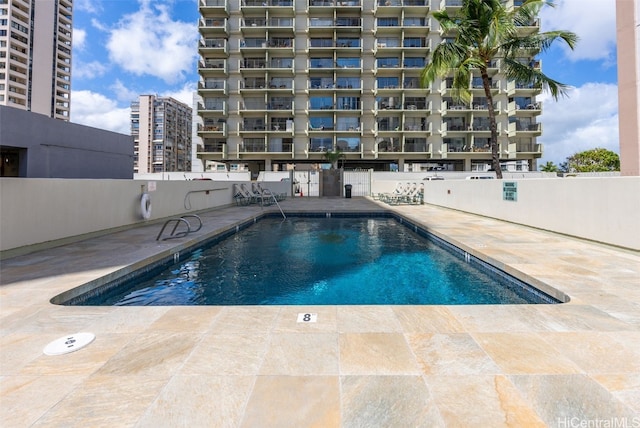 community pool with a patio area