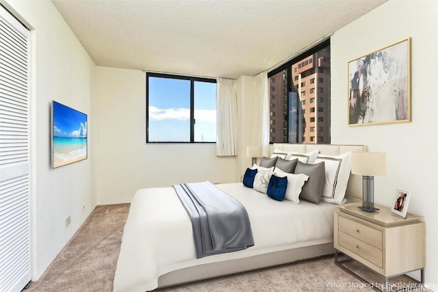 carpeted bedroom featuring a textured ceiling