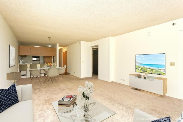 carpeted living room featuring a textured ceiling