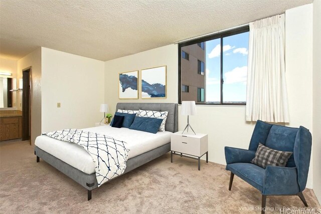 bedroom featuring a textured ceiling and carpet flooring