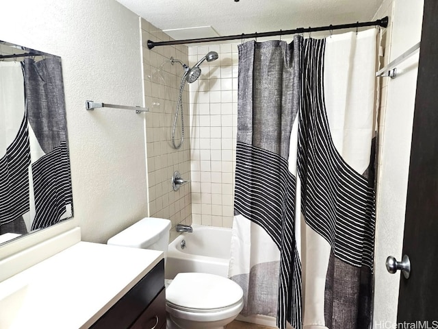 bathroom featuring a textured wall, toilet, shower / bath combo with shower curtain, a textured ceiling, and vanity