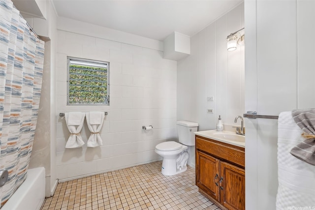 full bathroom featuring shower / tub combo, vanity, toilet, and tile patterned flooring