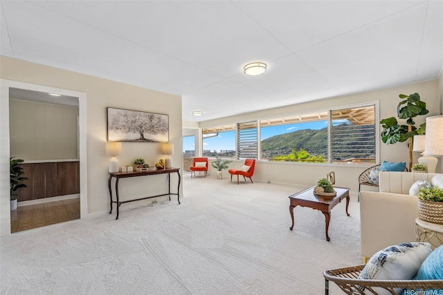carpeted living area featuring baseboards
