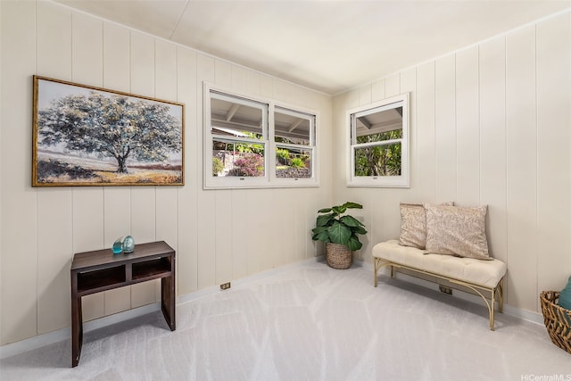 living area with baseboards and carpet flooring