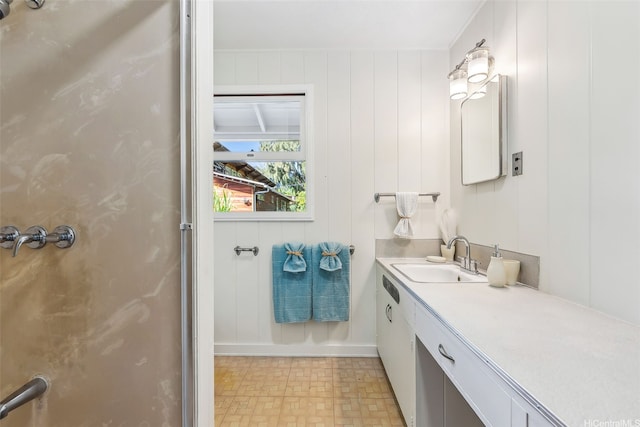 bathroom with a shower with shower door and vanity