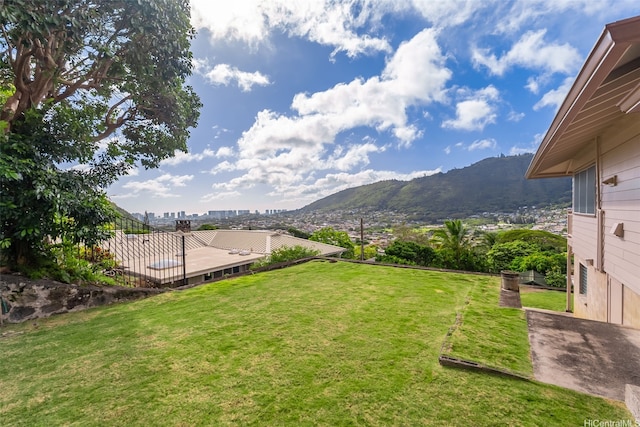 view of yard with a mountain view and fence